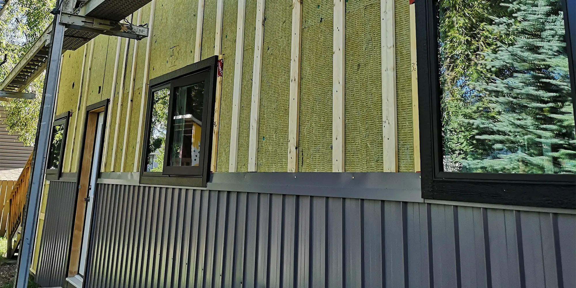 Yellow insulation is visible on unfinished home.